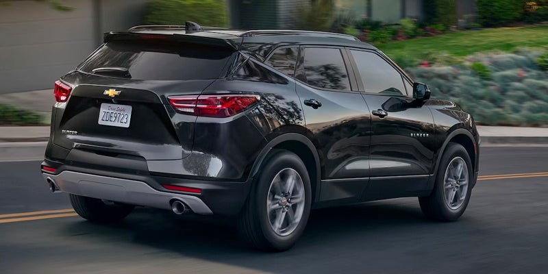 Black 2024 Chevrolet Blazer from the rear, highlighting its sporty shape and distinctive taillight design.