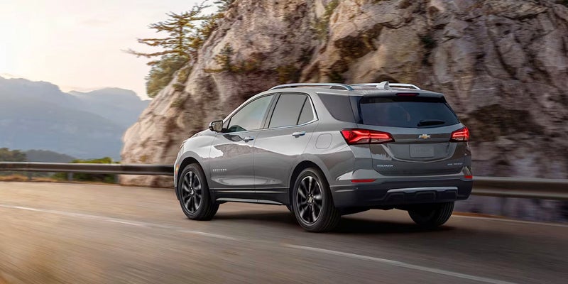A Chevrolet Equinox travels down a mountainous road.